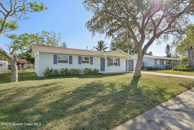 ranch-style home featuring a front lawn, an attached garage, and fence