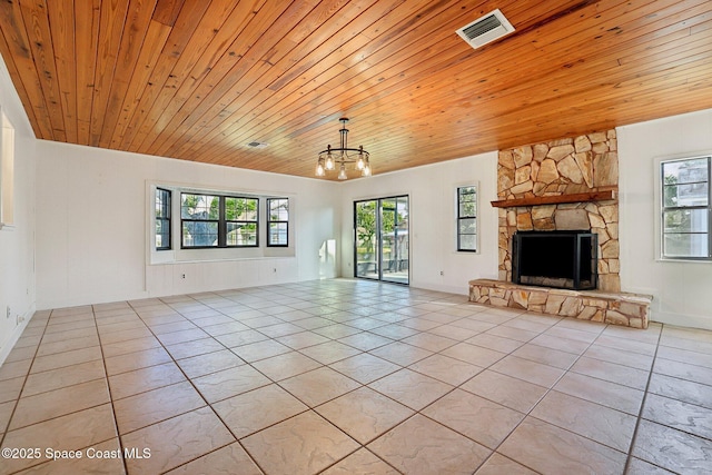 unfurnished living room featuring visible vents, an inviting chandelier, wooden ceiling, light tile patterned flooring, and a fireplace