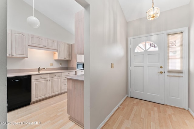 entryway with light wood-type flooring, lofted ceiling, and baseboards