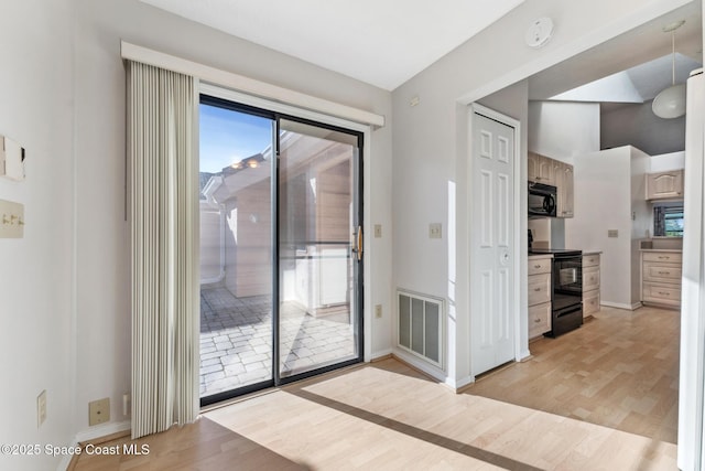 interior space with visible vents, baseboards, and light wood-style floors