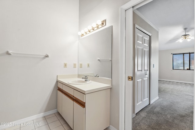 bathroom with baseboards, a ceiling fan, vanity, and tile patterned flooring