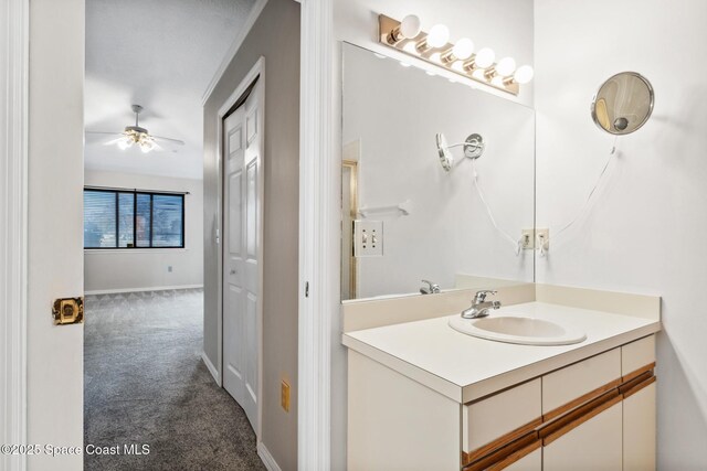 bathroom featuring baseboards, vanity, and ceiling fan