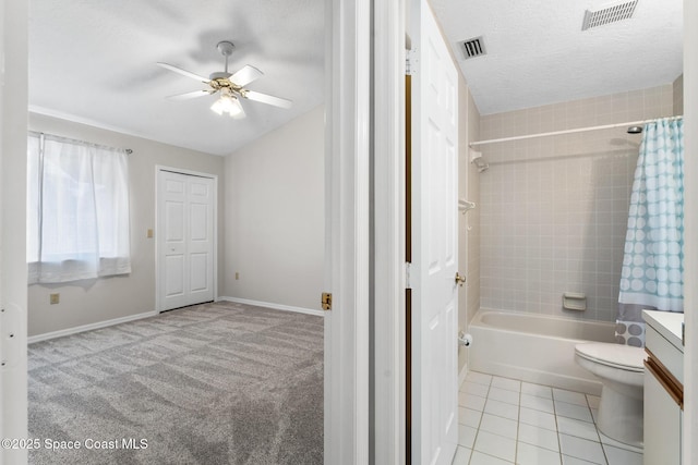 full bathroom with tile patterned floors, visible vents, toilet, and a textured ceiling