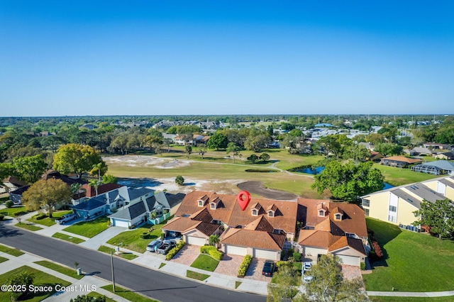 drone / aerial view with a residential view and view of golf course