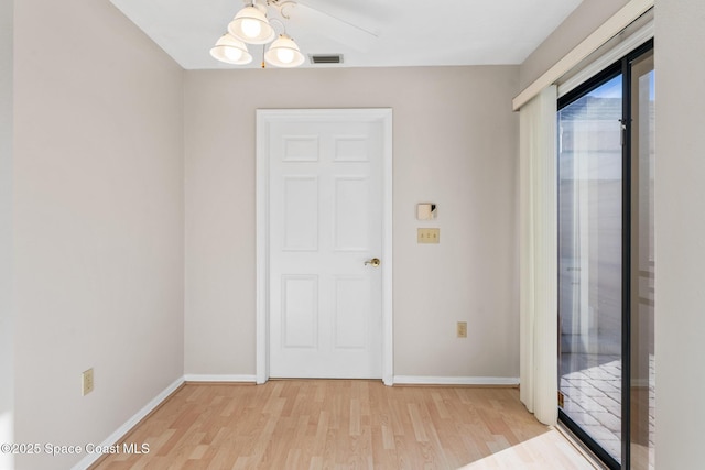 unfurnished room with light wood-style flooring, baseboards, and visible vents