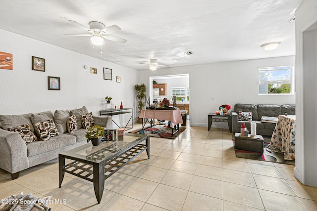 living room with light tile patterned floors, a ceiling fan, and visible vents