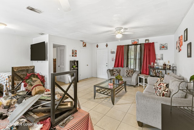 living room with light tile patterned floors, a ceiling fan, and visible vents