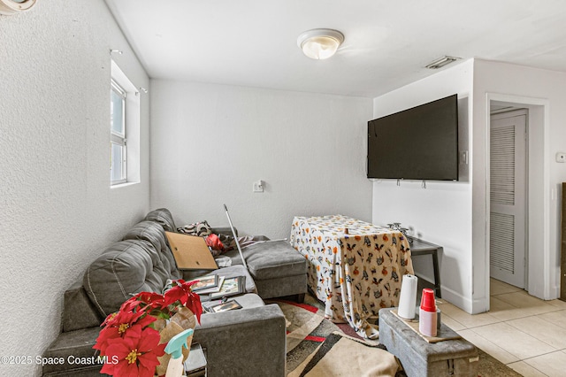 living room with light tile patterned floors and visible vents