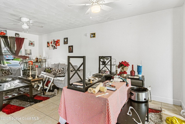 interior space featuring baseboards and ceiling fan