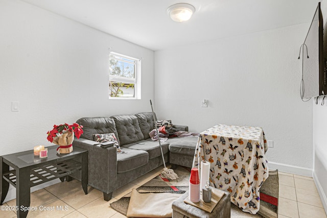 living room with light tile patterned floors and baseboards