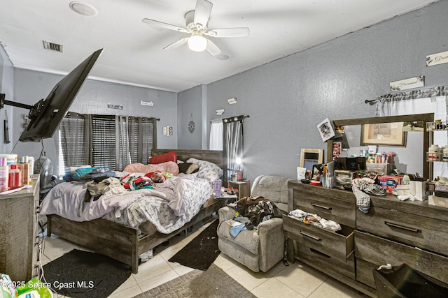 tiled bedroom featuring visible vents and a ceiling fan