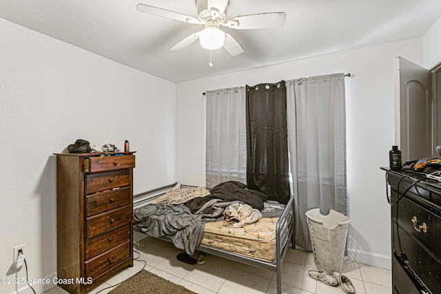 bedroom featuring light tile patterned floors and a ceiling fan