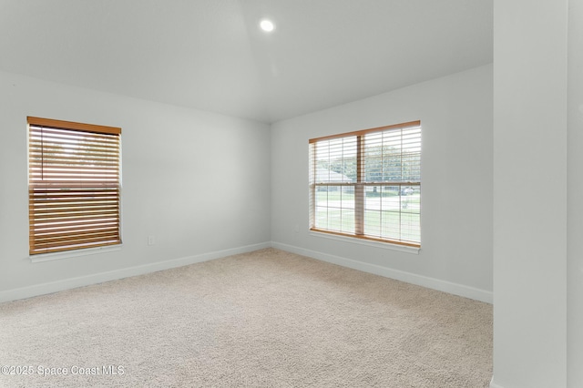 carpeted spare room with baseboards