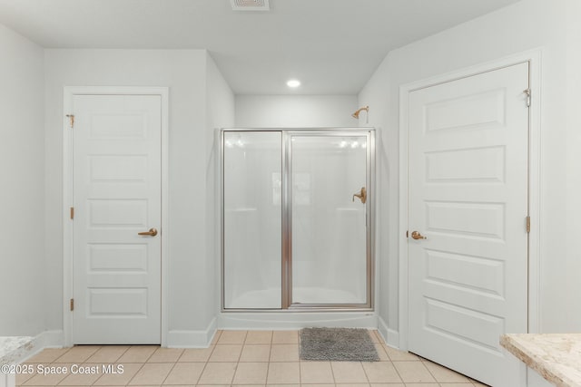 full bathroom with tile patterned floors, baseboards, a stall shower, and visible vents