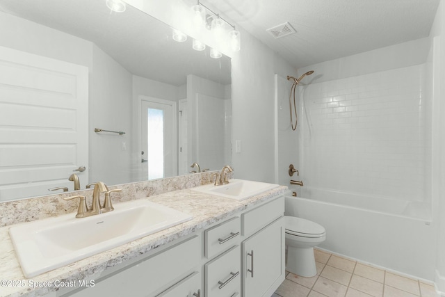 bathroom with tile patterned flooring, toilet, washtub / shower combination, and a sink