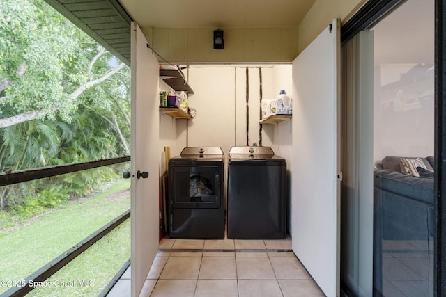 laundry area featuring laundry area, light tile patterned floors, plenty of natural light, and washer and clothes dryer