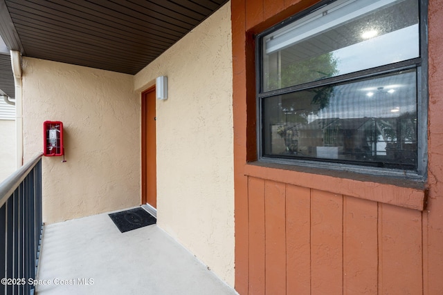 doorway to property featuring stucco siding