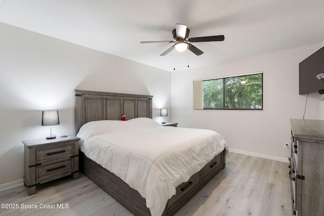 bedroom with baseboards, light wood finished floors, and ceiling fan