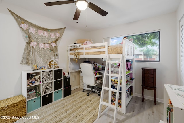 bedroom featuring ceiling fan, baseboards, and wood finished floors