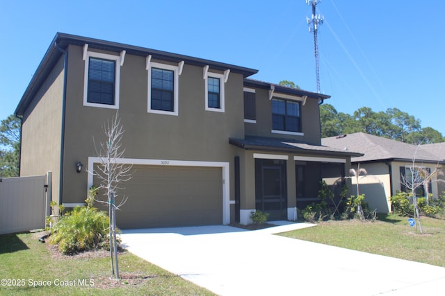 view of front of home with stucco siding, a front lawn, concrete driveway, an attached garage, and a sunroom