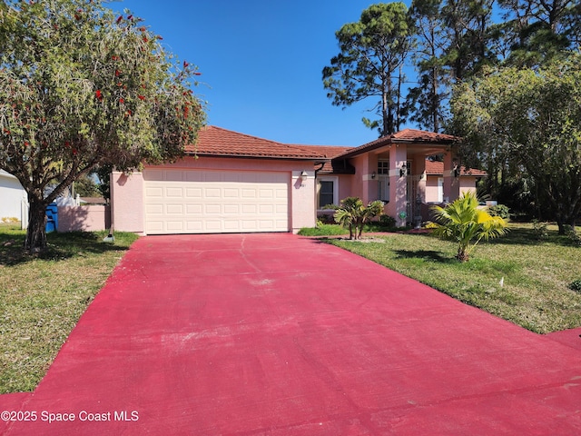 view of front of house with a front yard, driveway, stucco siding, a garage, and a tile roof