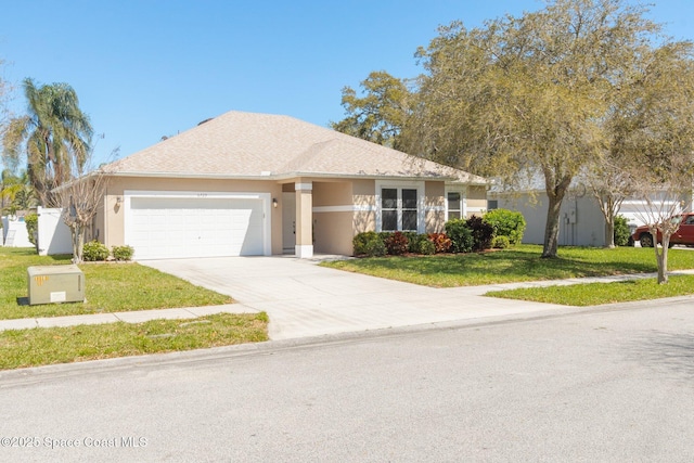 single story home with stucco siding, concrete driveway, a front yard, and a garage