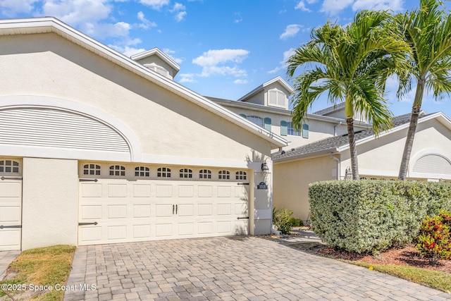 exterior space featuring decorative driveway