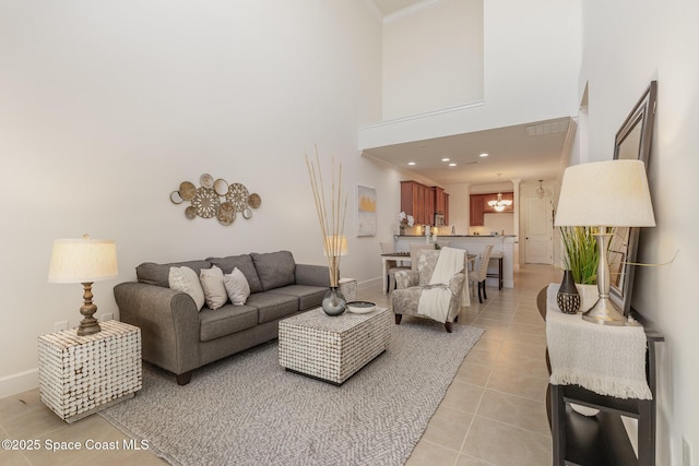 living room with crown molding, baseboards, light tile patterned floors, recessed lighting, and a towering ceiling