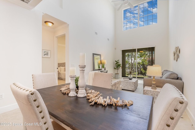 dining area with baseboards, a ceiling fan, visible vents, and ornamental molding