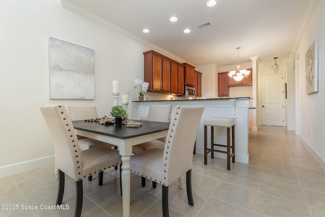 dining area featuring visible vents, light tile patterned flooring, crown molding, baseboards, and a chandelier