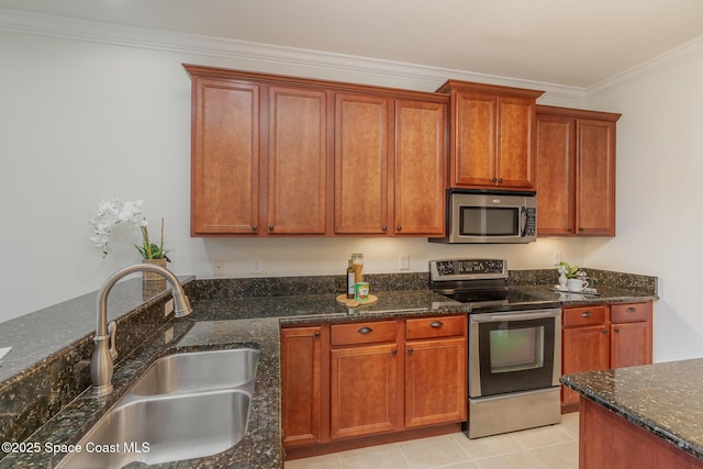 kitchen featuring ornamental molding, appliances with stainless steel finishes, dark stone counters, and a sink