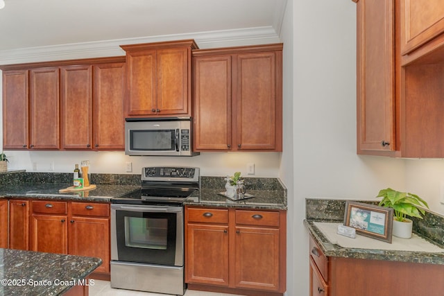 kitchen with dark stone counters, brown cabinetry, crown molding, and stainless steel appliances