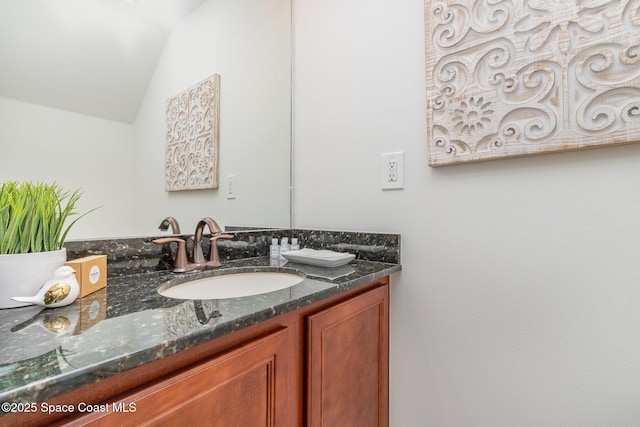 bathroom featuring vanity and vaulted ceiling