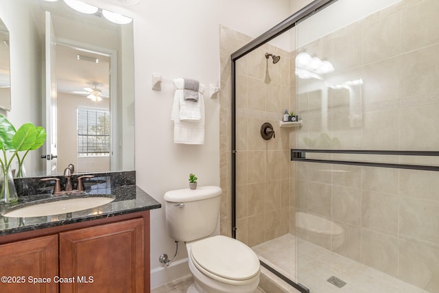 full bathroom with visible vents, a shower stall, toilet, vanity, and a ceiling fan