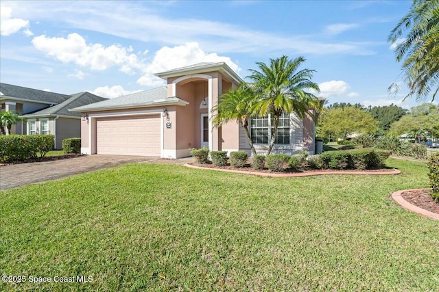 view of front facade with decorative driveway, a front yard, an attached garage, and stucco siding