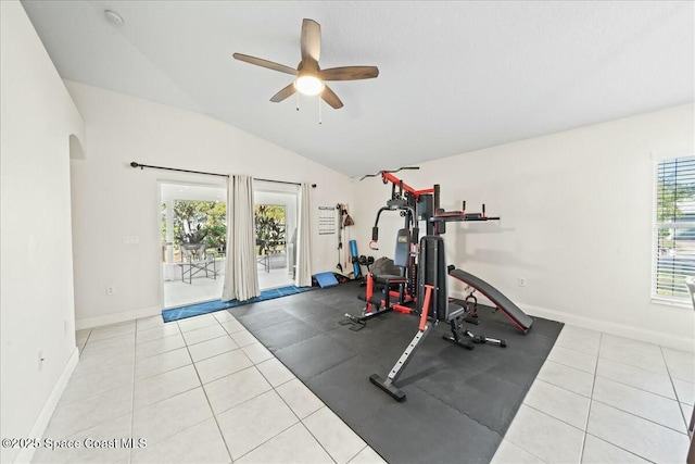 exercise room featuring lofted ceiling, a ceiling fan, baseboards, and arched walkways