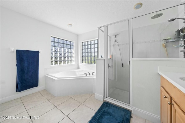 full bathroom with vanity, tile patterned floors, a garden tub, and a stall shower