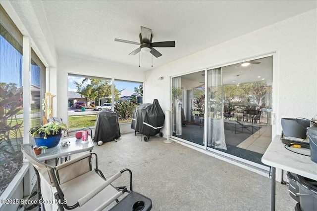 sunroom featuring a ceiling fan