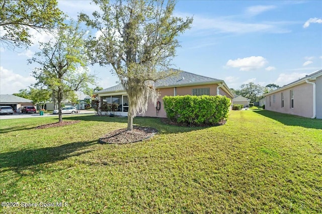 view of yard with a sunroom