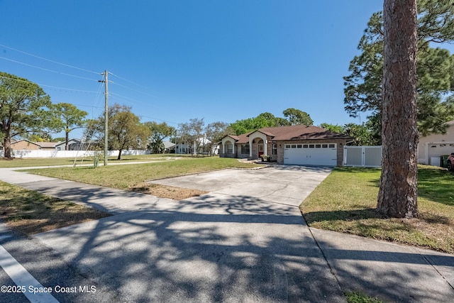 view of front of house featuring a gate, fence, driveway, a front lawn, and a garage