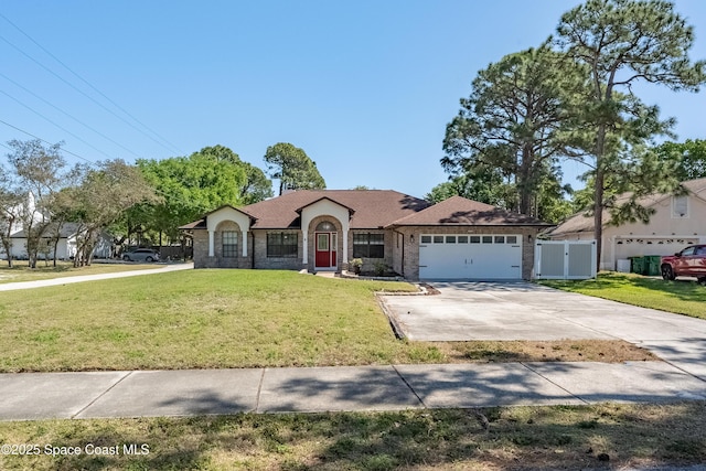 ranch-style home with driveway, fence, an attached garage, a front yard, and brick siding