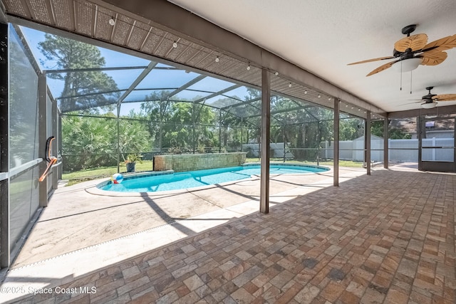 view of swimming pool featuring a fenced in pool, fence, a lanai, a patio area, and a ceiling fan