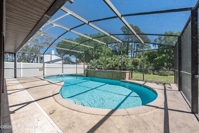 view of pool featuring glass enclosure, fence, a patio area, and a fenced in pool