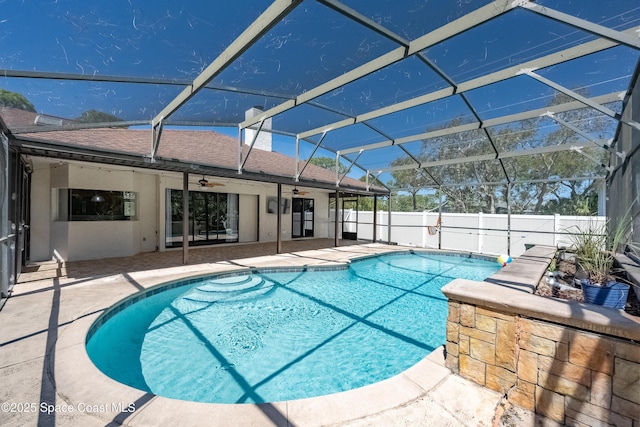 view of swimming pool featuring a ceiling fan, a patio, fence, a fenced in pool, and a lanai