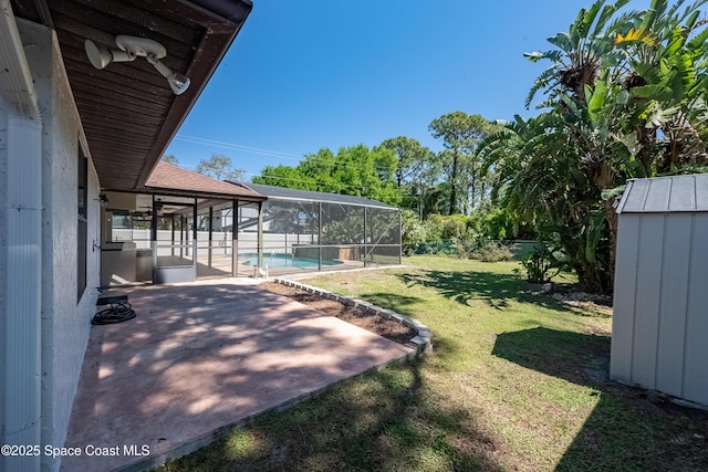 view of yard with glass enclosure, an outdoor pool, and a patio