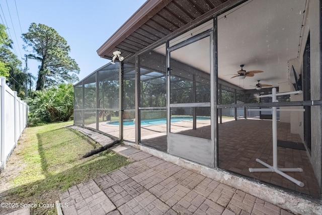 view of patio / terrace featuring a lanai, a fenced backyard, a fenced in pool, and ceiling fan