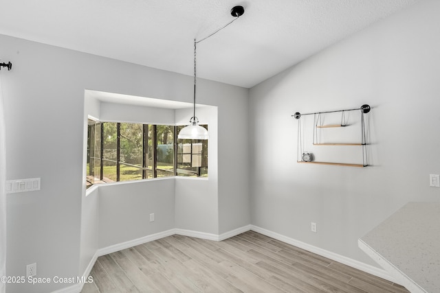 empty room featuring light wood-style flooring and baseboards