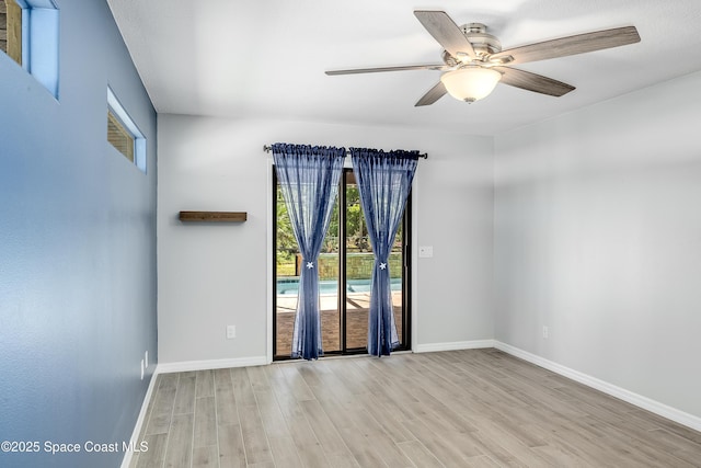 unfurnished room with a ceiling fan, wood finished floors, and baseboards