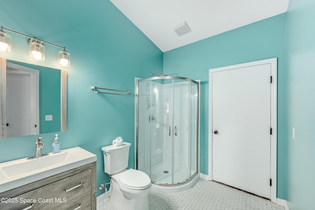 full bathroom featuring baseboards, a shower stall, vanity, and toilet