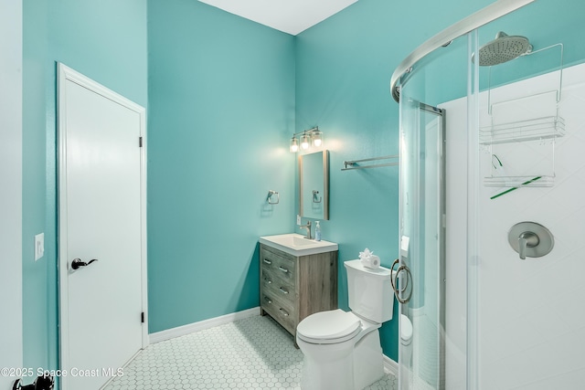 bathroom with vanity, baseboards, a shower stall, tile patterned floors, and toilet